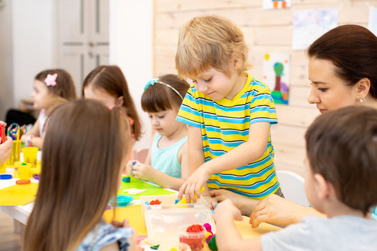 Large group of preschool children with teacher on lesson class in kindergarten