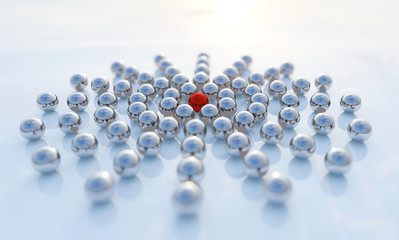 Concept or conceptual collection of balls with a red one standing out on blue background as a metaphor for creativity, leadership and independence. A courage, action and success 3d illustration