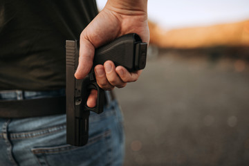 Man with a gun, close-up, copy space.