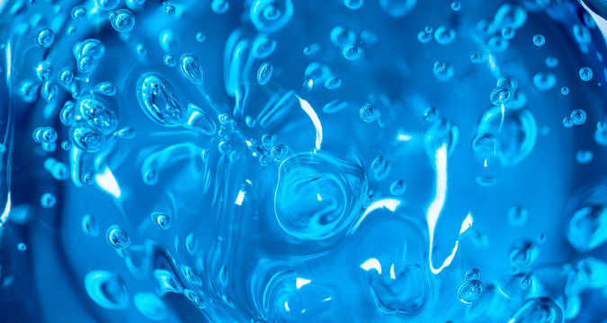 Water blue gel balls. Polymer gel. Silica gel. Balls of blue hydrogel. Crystal liquid ball with reflection. Texture background. Close up macro. Soapsuds background with air bubbles