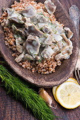Stewed turkey stomachs with vegetables and buckwheat in a bowl