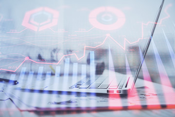 Forex graph hologram on table with computer background. Multi exposure. Concept of financial markets.