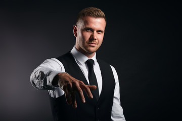 Naklejka premium funny office worker giving hand for an handshake to seal the agreement isolated on black background, busisness,man is dancing, singing a rep. close up portrait,