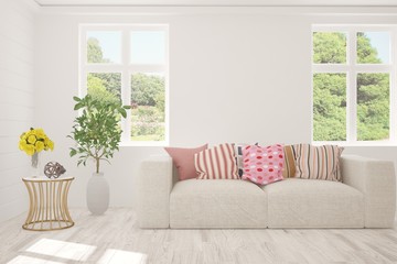 Naklejka premium Stylish room in white color with sofa and summer landscape in window. Scandinavian interior design. 3D illustration