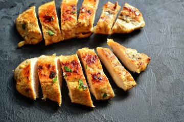 Grilled chicken breast. Appetizing grilled chicken fillet. Meat with vegetables, broccoli and mushrooms. Food on a dark background