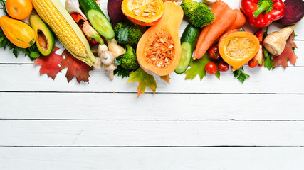 Fresh autumn vegetables on white wooden background. Healthy food.