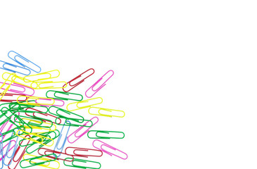 Colored paper clips on white background. A lot of paper clips