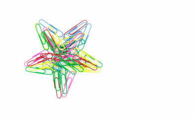 Series of colorful paper clips with star shape on white background. Decorative paper clips in pink,...