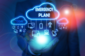 Conceptual hand writing showing Emergency Plan. Concept meaning actions developed to mitigate damage of potential events Male wear formal suit presenting presentation smart device