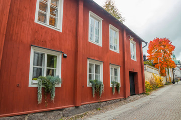 Fototapeta na wymiar Street of Old Porvoo, Finland. Beautiful city autumn landscape with colorful wooden buildings.