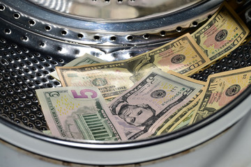 Banknotes in the washing machine, money laundering. Process of making illegally-gained proceeds...