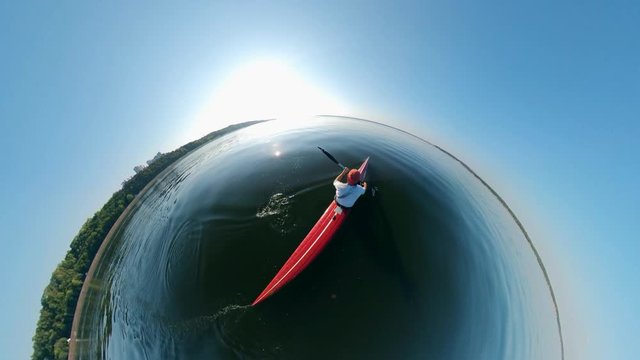 A man is navigating a canoe in a semi-circle view