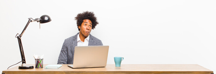 young black businessman feeling sad and stressed, upset because of a bad surprise, with a negative,...