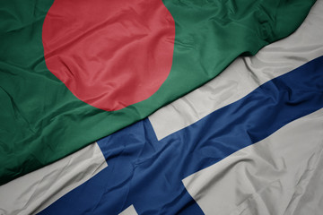 waving colorful flag of finland and national flag of bangladesh.