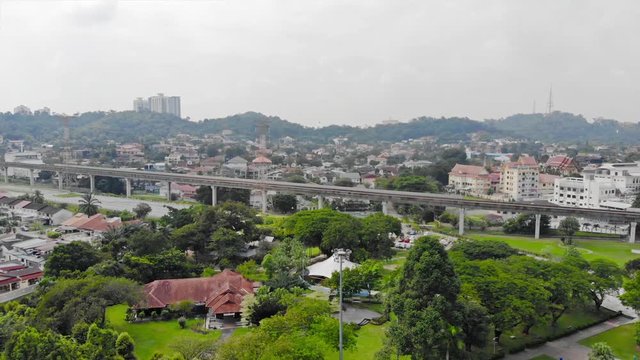 Top Aerial View Of Green Park Full With Tree Near Of Toll Road In Taman Jaya Park - Dolly Right To Left 