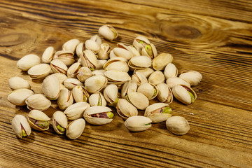 Pistachio nuts on a wooden table