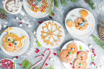 Various funny kid Christmas breakfast pancakes set - in form of snowflakes, Christmas tree, snowman, santa deer, mouse, With xmas decoration copy space