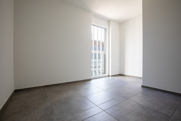 Empty room with white walls and bright window