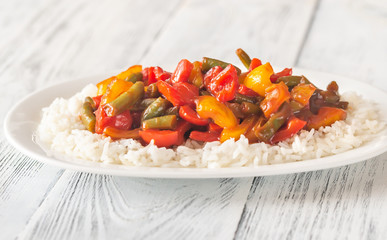 Portion of white rice and fried vegetables