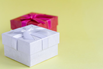 white and red gift boxes on yellow background