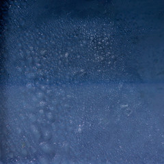 Newly fallen snow and ice  on blue Background.