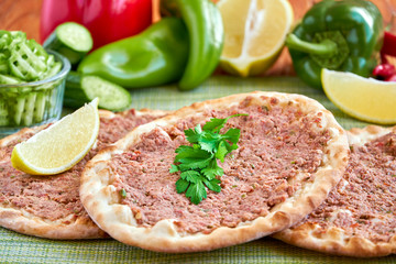 Meat with dough, manakeesh meat, arabiac flat bread with meat. Close up