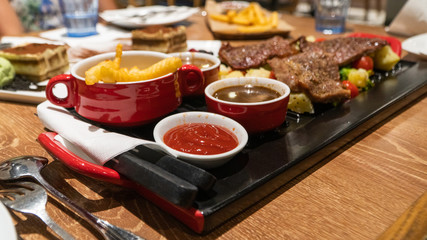 beef steak with french fries and herbs