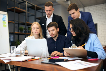Group of successful clever business people analyzing and discussing problems at the meeting in the modern office room. close up photo.