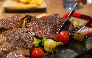 beef steak with french fries and herbs