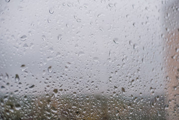 Rainy autumn day, drops on the window. Background with water drops