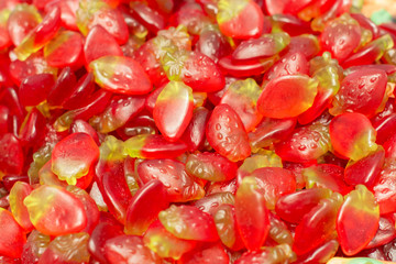 Strawberry marmalade in the form of ripe berries, jelly sweets background close-up. Sweets at the supermarket counter.