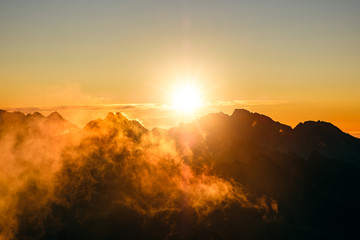 Sun rising over the beautiful mountains and clouds in High Tatras, Slovakia