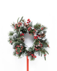 Snowy festive wreath on white background