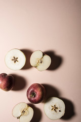 Apples and apple slices on pastel background. Top view shot, abstract food conception.