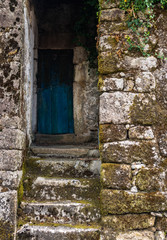 Blue old door on a small traditional granite house in north of portugal