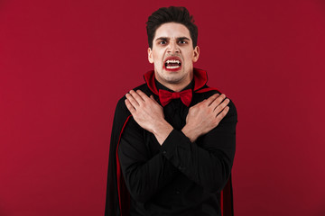Image of vampire man in black halloween costume standing as undead