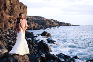 Happy couple just married at the oceanside