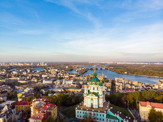 Aerial top view of Saint Andrew's church and Andreevska street from above, cityscape of Podol district, city of Kiev (Kyiv), Ukraine