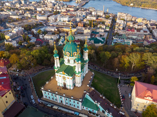 Aerial top view of Saint Andrew's church and Andreevska street from above, cityscape of Podol district, city of Kiev (Kyiv), Ukraine