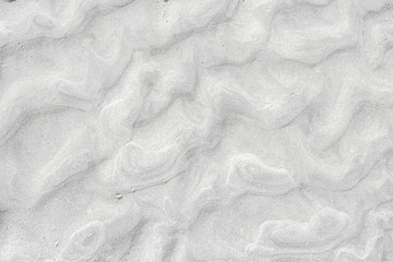 A top down shot of a white river sand bottom full of texture and salt marks. Useful as abstract background.