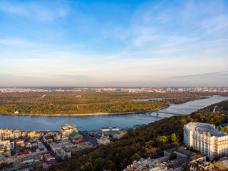 Aerial top view of Kyiv cityscape, Dnieper river and Podol historical district skyline from above, Kontraktova square with ferris wheel, city of Kiev, Ukraine