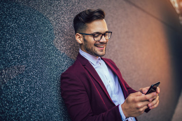Young and successful businessman using mobile phone