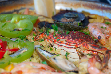 Spanish Seafood Paella with Shrimps, Paprika and Lemon. Selective focus.