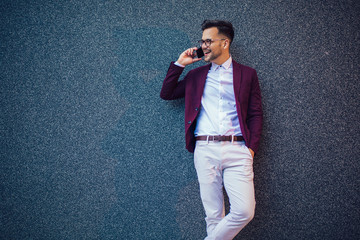 Young and successful businessman using mobile phone