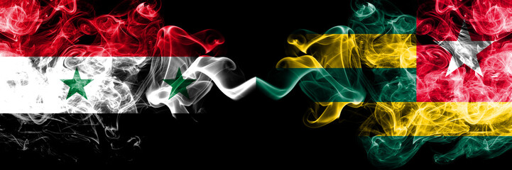 Syria vs Togo, Togolese smoke flags placed side by side. Thick colored silky smoke flags of Syrian and Togo, Togolese