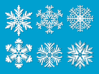 Fototapeta na wymiar Set of six white paper cut out highly detailed snowflakes on blue background. Vector illustration