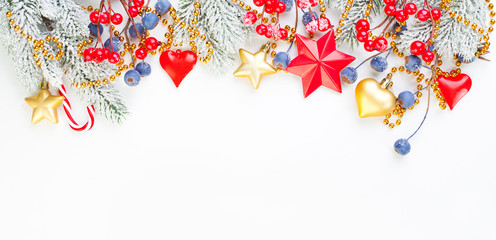 Christmas composition with holly berries, snowflake and green fir branch on white background. Xmas...