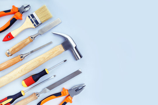 Different construction tools for home renovation on grey background with copy space. Maintenance and reparing concept.
