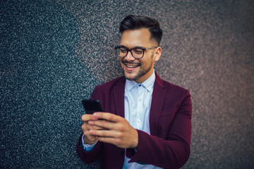 Young and successful businessman using mobile phone