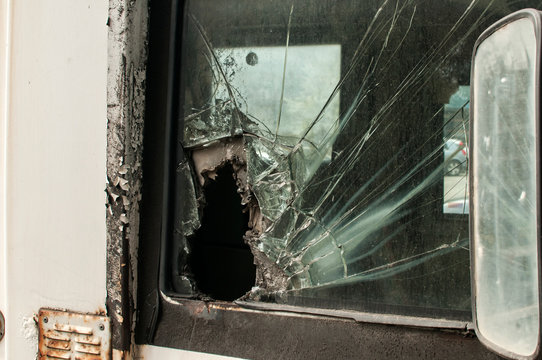 Broken side glass of armored bank truck closeup
